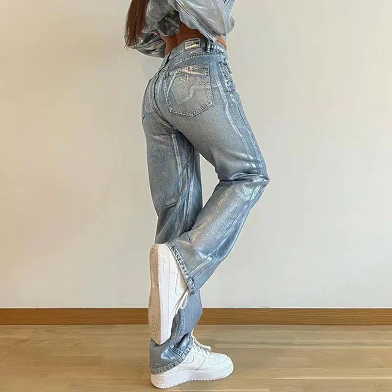 Washed blue high waist straight leg jeans on a model, showing contrast colour details.