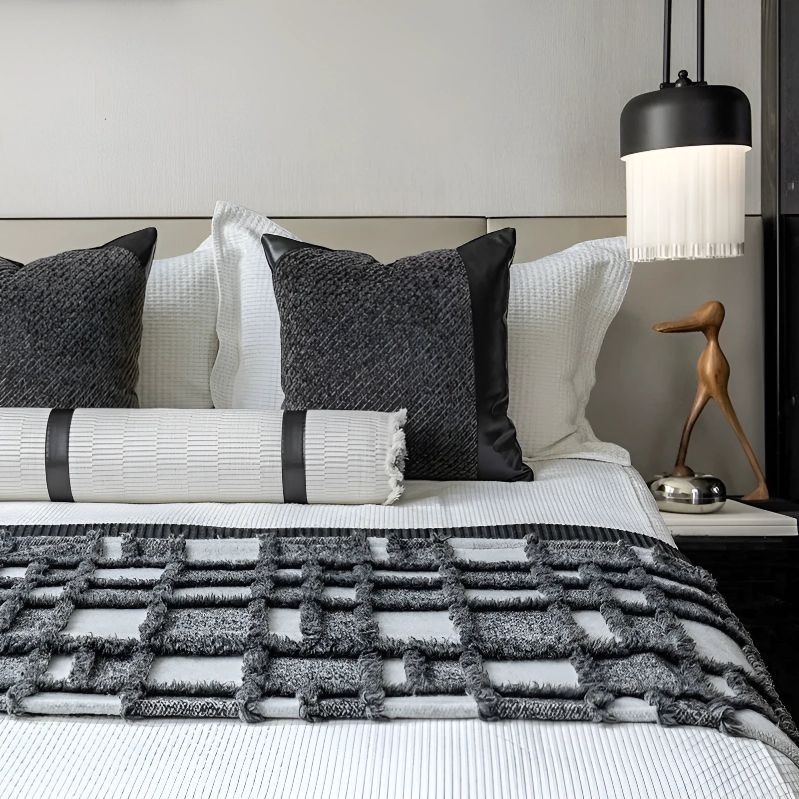 Modern minimalist grey and white plaid bed runner blanket set with matching pillow on a double bed