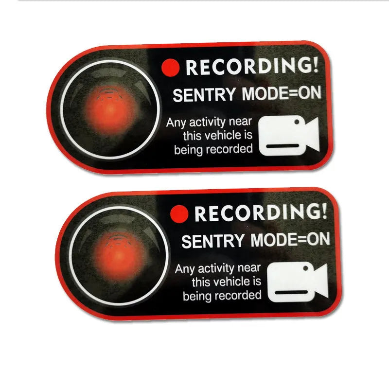 Pair of white electrostatic PVC warning stickers for Tesla car sentry mode, measuring 11 by 5 centimetres.