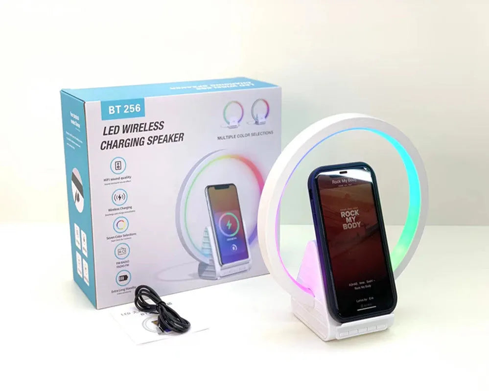 White smart Bluetooth speaker with ambient light ring and wireless charging surface