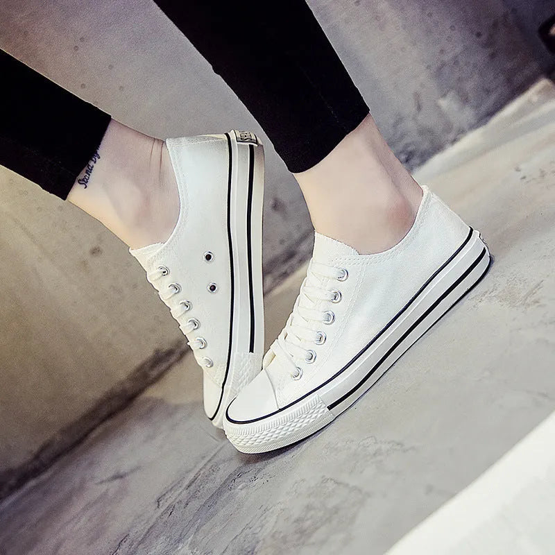 Women's canvas shoes in solid colours including black, white-black, white-red, and all-black variations