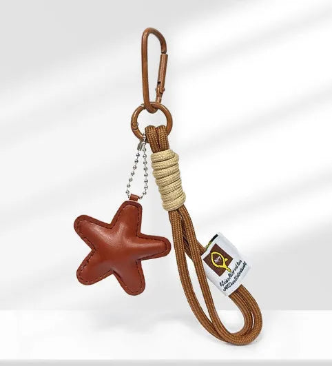 Handbag pendant charm with handmade soda bread design patterns including brown star, croissant, and bagel