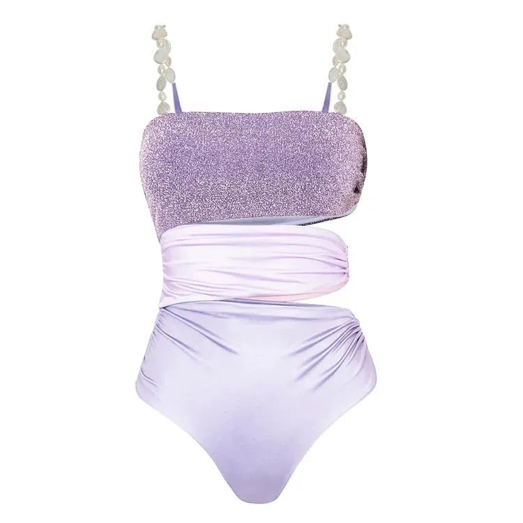 Purple one-piece swimsuit with coordinating wrap skirt set on beach background