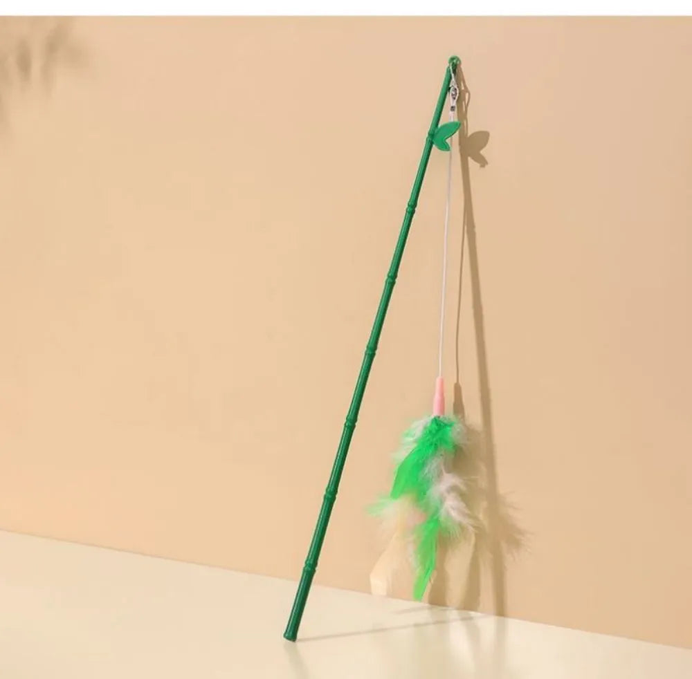 Green interactive cat feather wand toy with bells and synthetic feather attachments