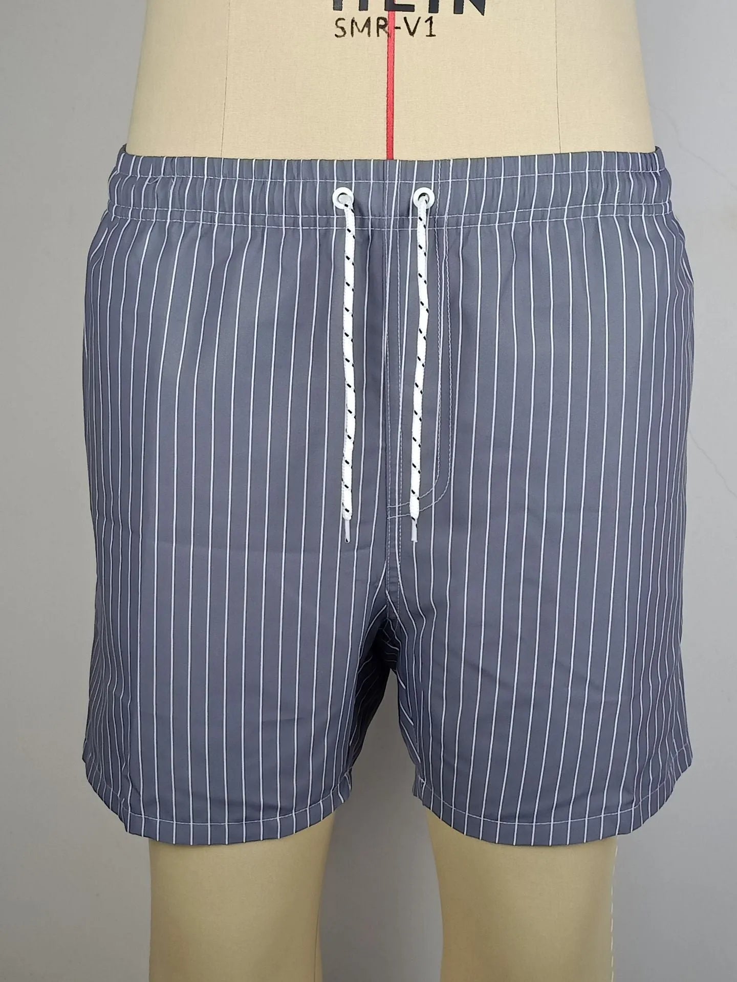 Polyester striped beach shorts with straight leg opening in navy blue, grey, khaki, or light blue colour options