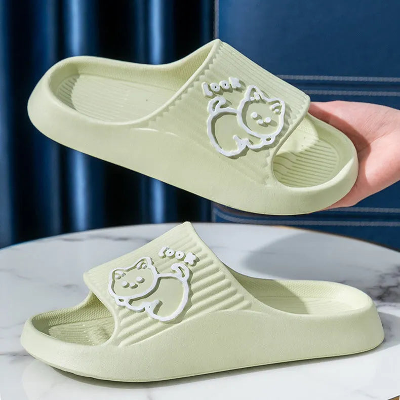 Green EVA platform flip flop slippers with a raised cat design on the upper.