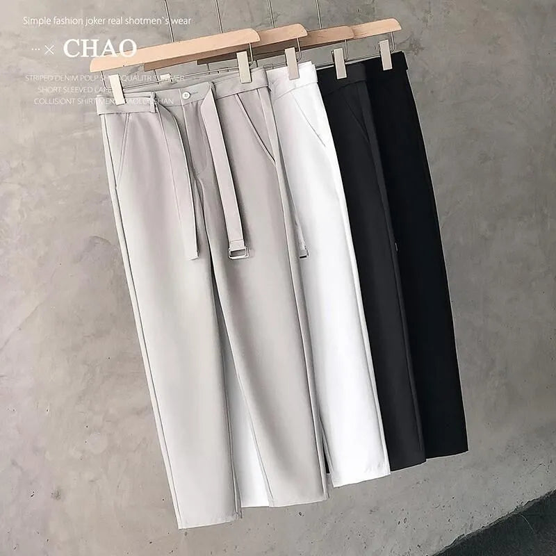 Boys slim straight tapered wool trousers in light grey on a hanger, showing the straight leg opening and business casual style.