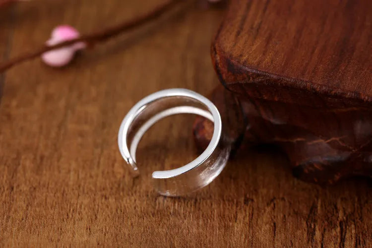 Geometric adjustable open ring with frosted sterling silver finish and Korean-inspired design