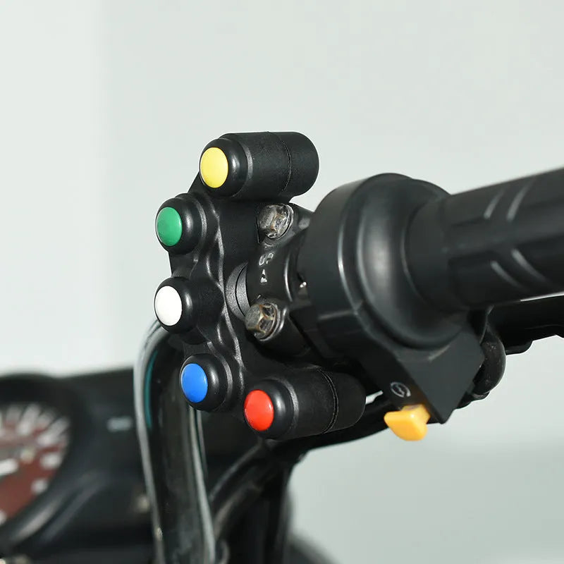 Plastic five-position switch with red, yellow, blue, green, and white buttons for motorcycle electrical modifications.