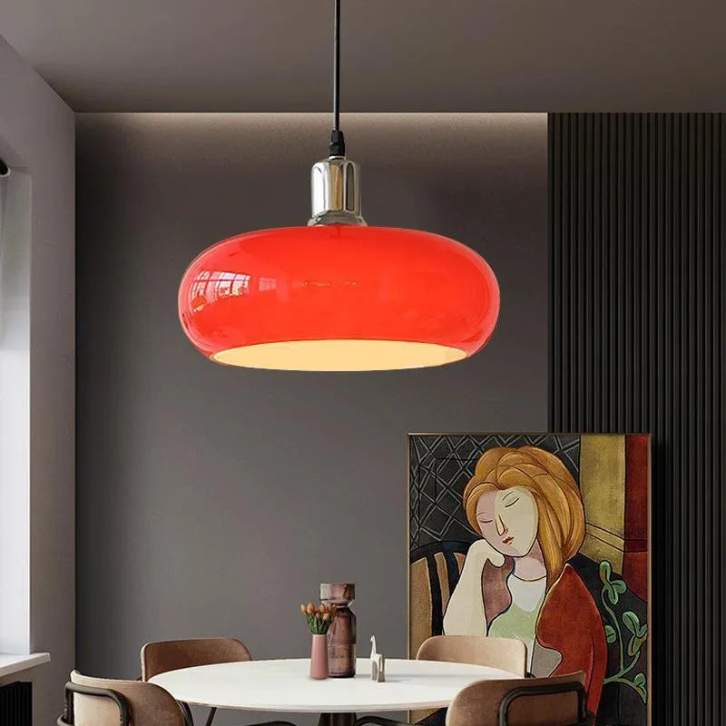 Three-headed Bauhaus pendant light with milky white glass egg tart shades hanging from a ceiling.