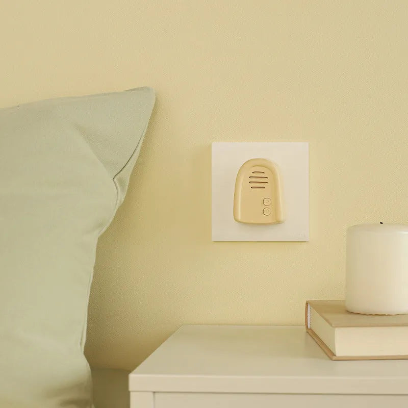 Wireless self-generating beeper doorbell unit in milky yellow or white colour with plug-in power cord.