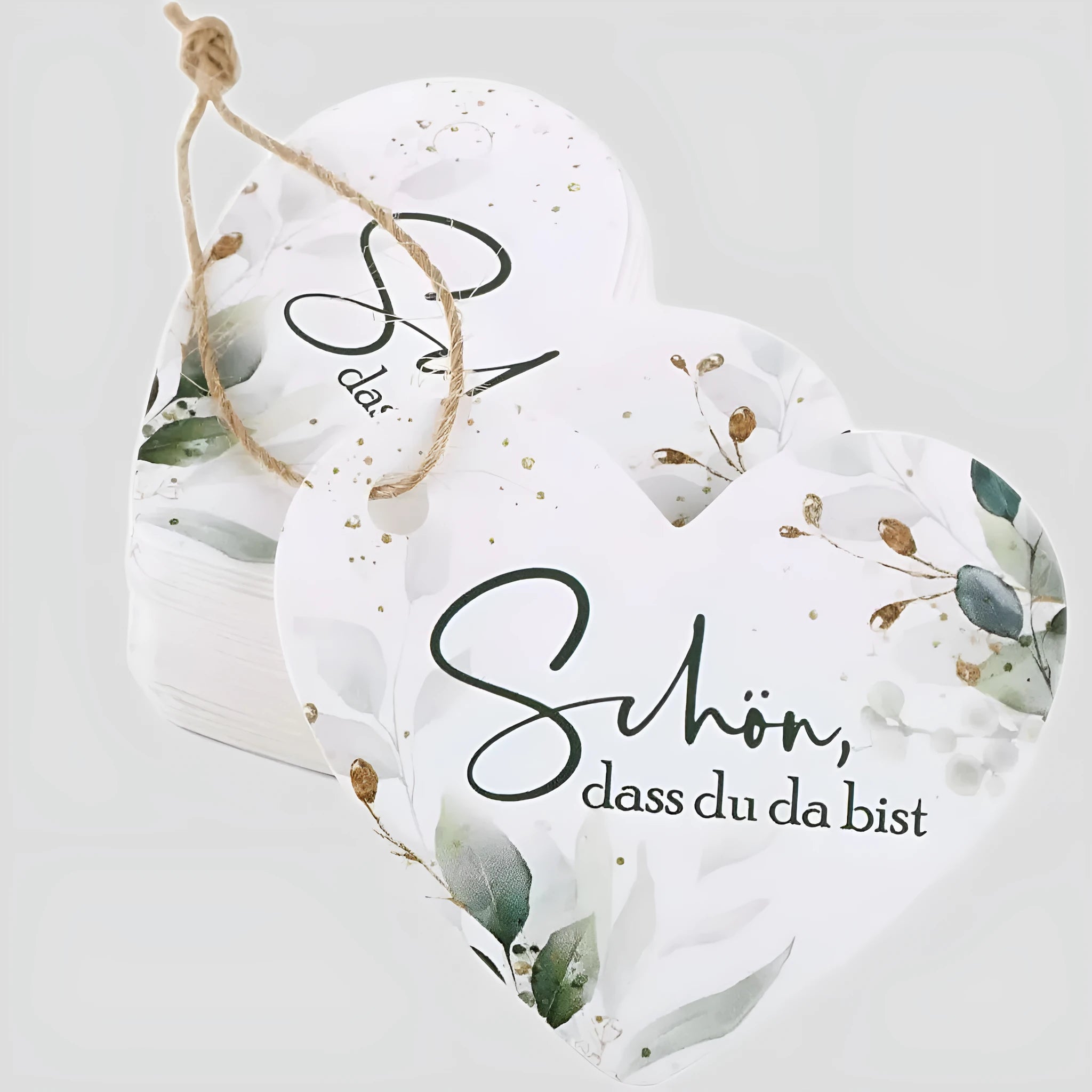 50 flower and heart-shaped paper gift tags in two colour style options, laid out flat.