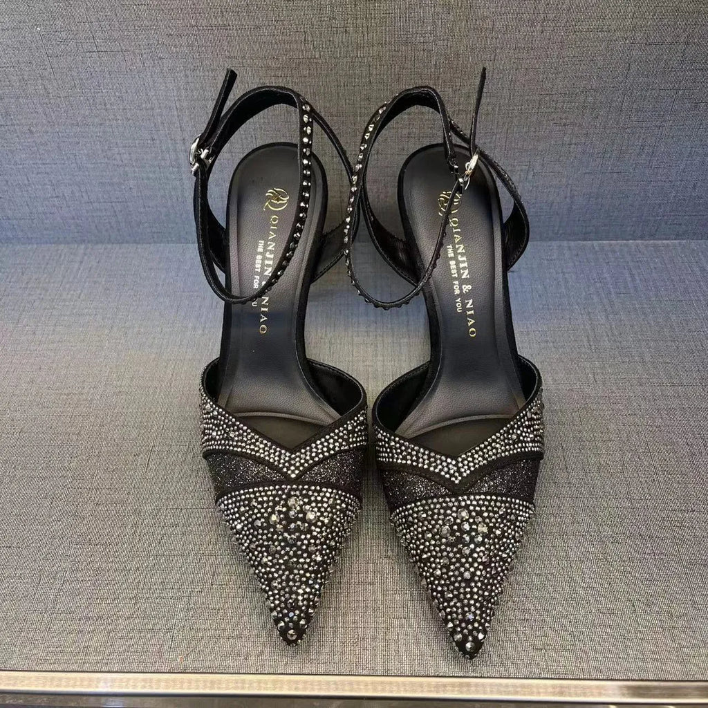 Women's black hollow high heels with red sole, stiletto heel and pointed toe design