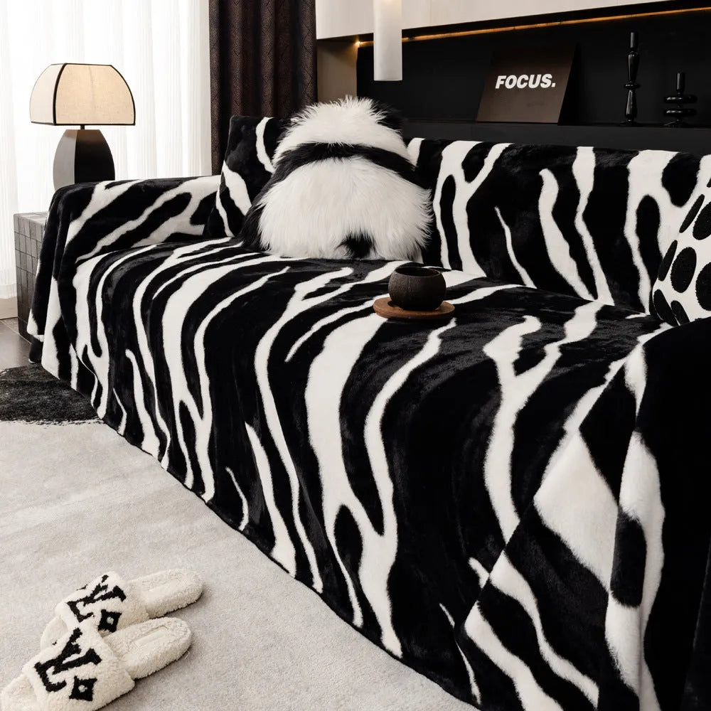 Thickened flannel zebra pattern sofa cover in caramel or black draping over a sofa with non-slip texture visible