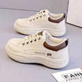Women's white Korean-style leather pumps with cross straps and a flat mid-height heel.