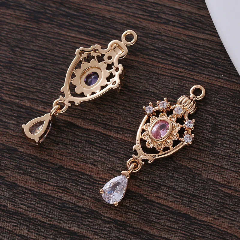 Small hollow water drop-shaped pendant with crown design and micro zircon details in various colours.