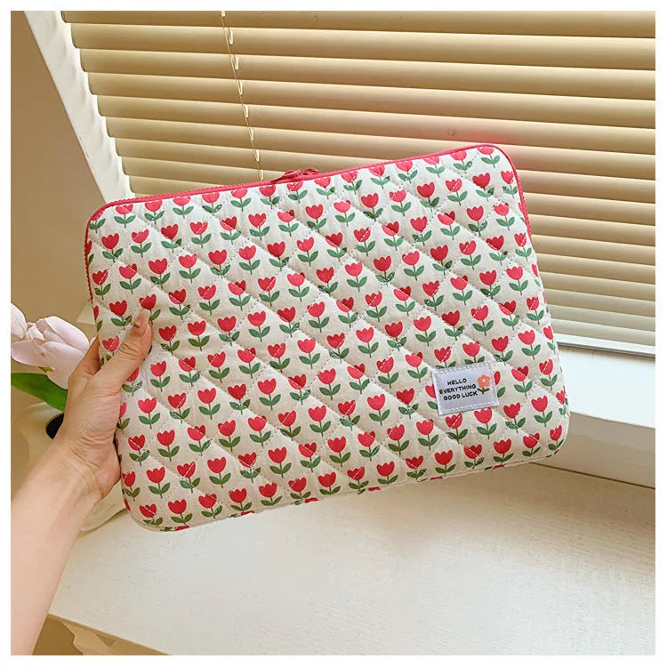 Flower print cloth laptop bag in green floral pattern showing three size options for laptop protection