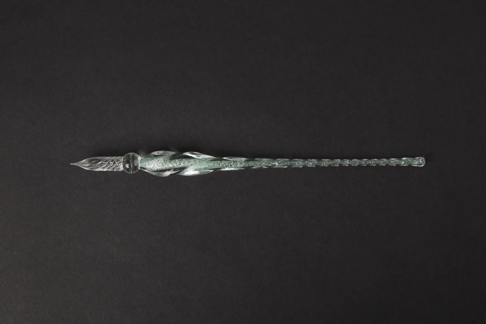 Transparent glass signature pen with coloured ink visible inside, abstract modelling, gift box packaging