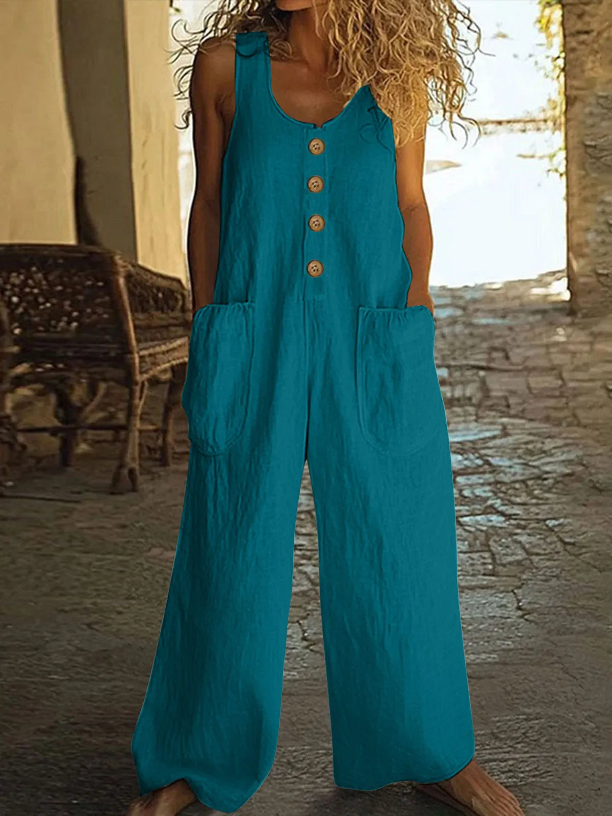 Sleeveless wide leg cotton jumpsuit in peacock green colour showing loose fit and pocket detail.