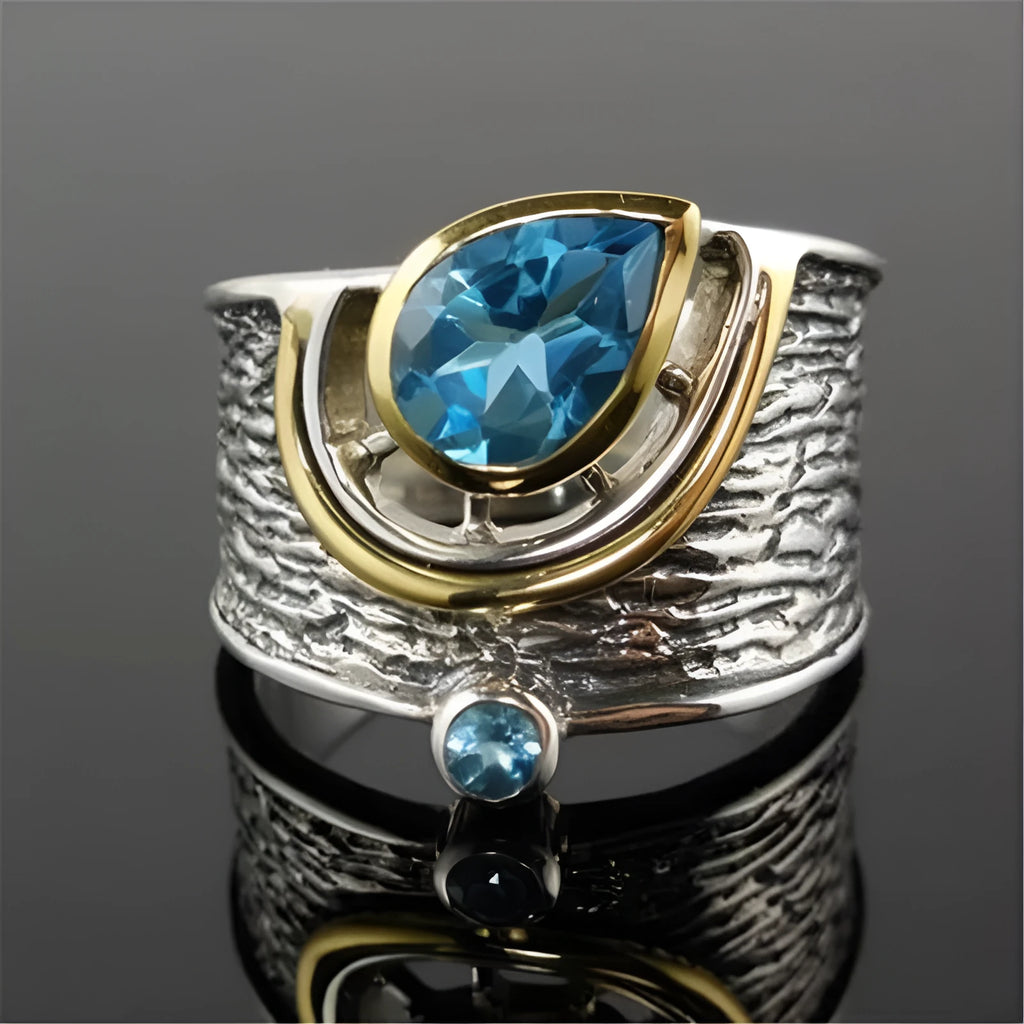 Close-up of a women's blue zircon alloy ring with Chinese style drop shape design and rhinestone inlay.