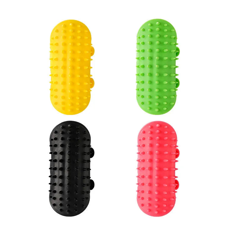 Silicone cat grooming comb with adjustable strap mounted on a table leg, shown in assorted colours.