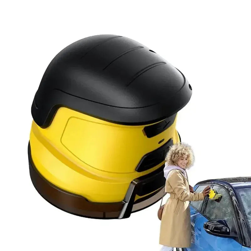 Yellow cordless electric ice scraper with USB charging cable on a car windscreen.