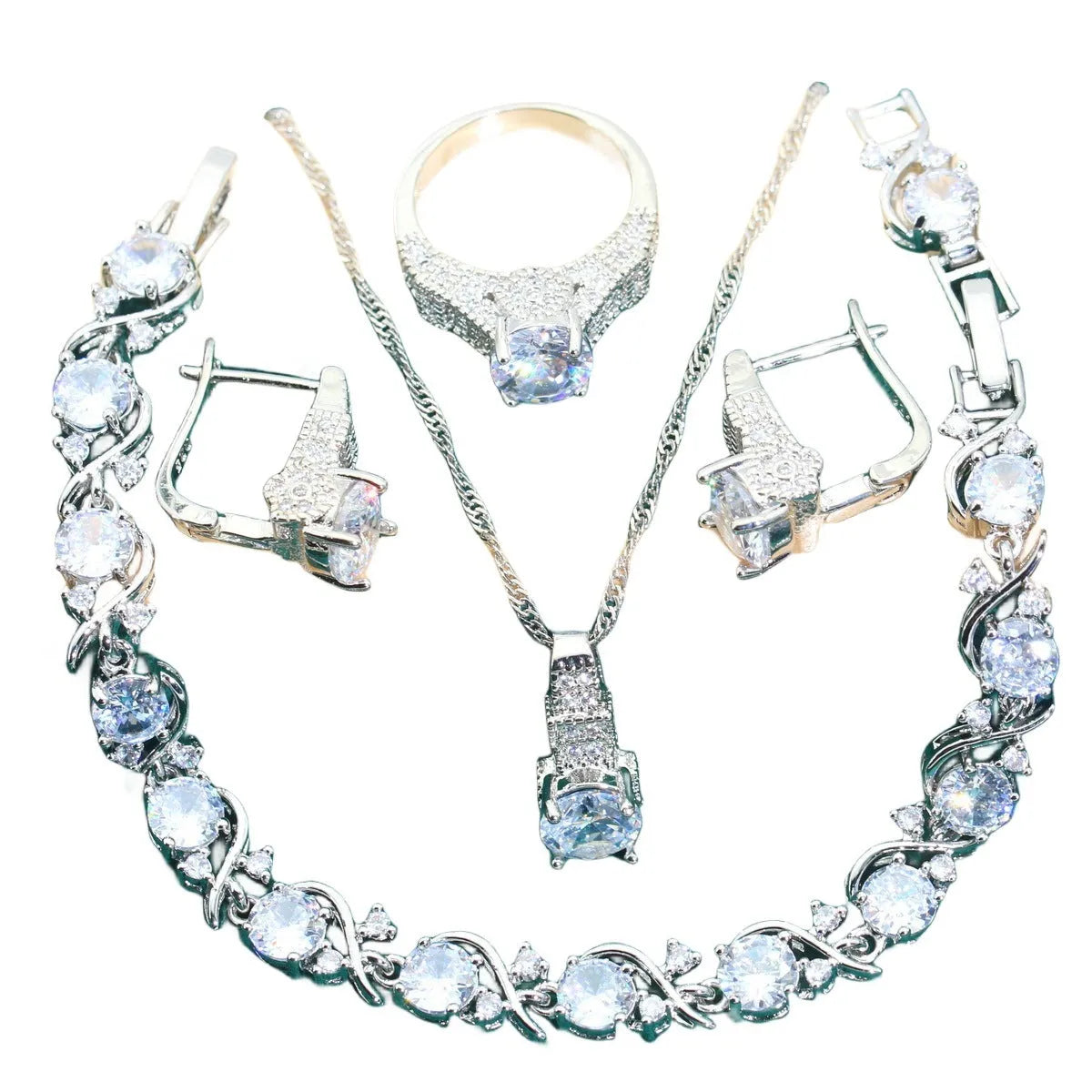 Four-piece bridal jewellery set showing necklace, earrings, ring, and bracelet with zircon alloy pendants