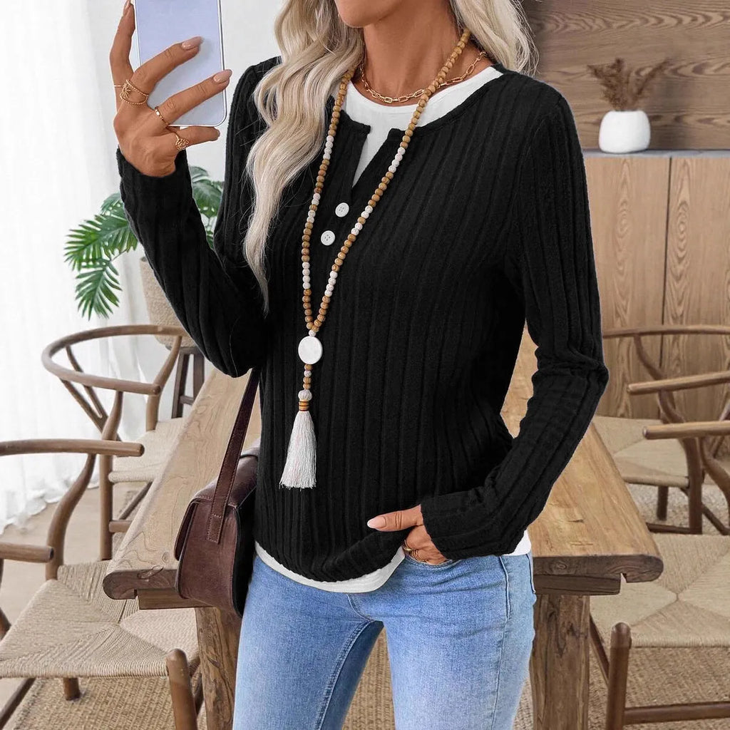 Women's black fake two-piece pullover sweater with round neck and long sleeves.