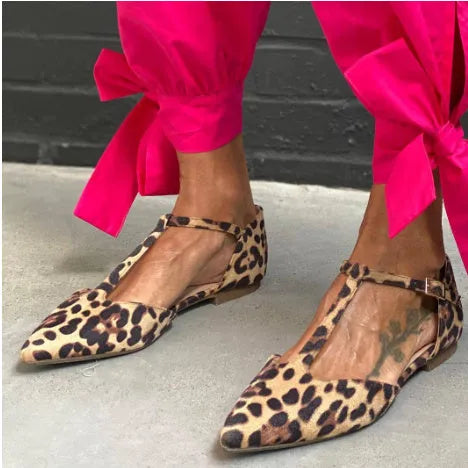 Women's leopard print pointed toe pumps with a chunky low heel and cross shoulder straps.