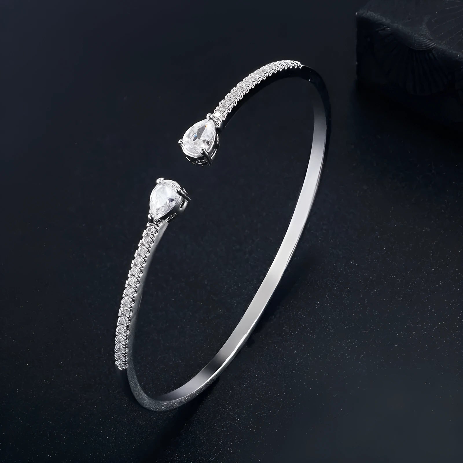 Copper bracelet with inlaid white zircon stones on a wrist.
