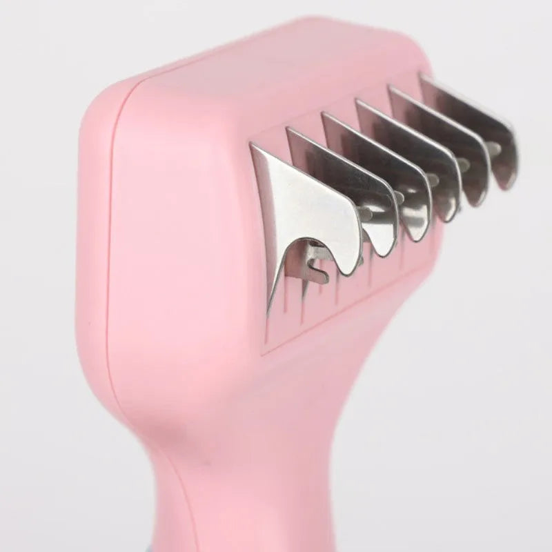 Pink pet grooming comb with stainless steel knot knife, massage brush head, and comb teeth on a white background.