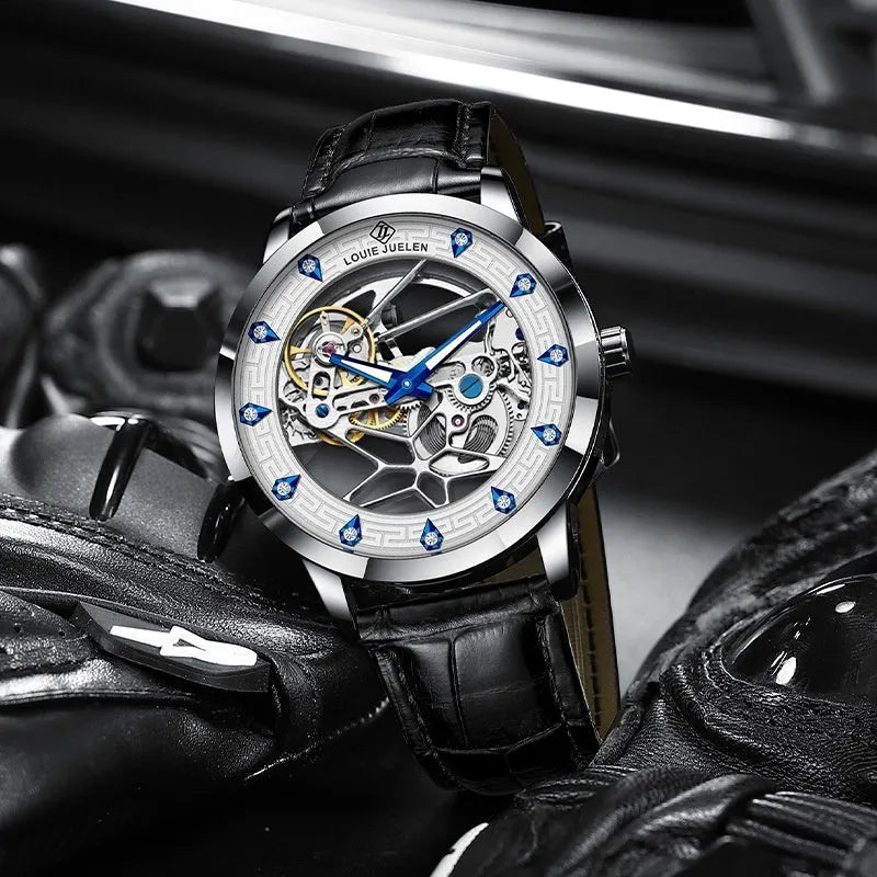 Men's silver case mechanical watch with black leather strap, white face, blue hands, and business styling