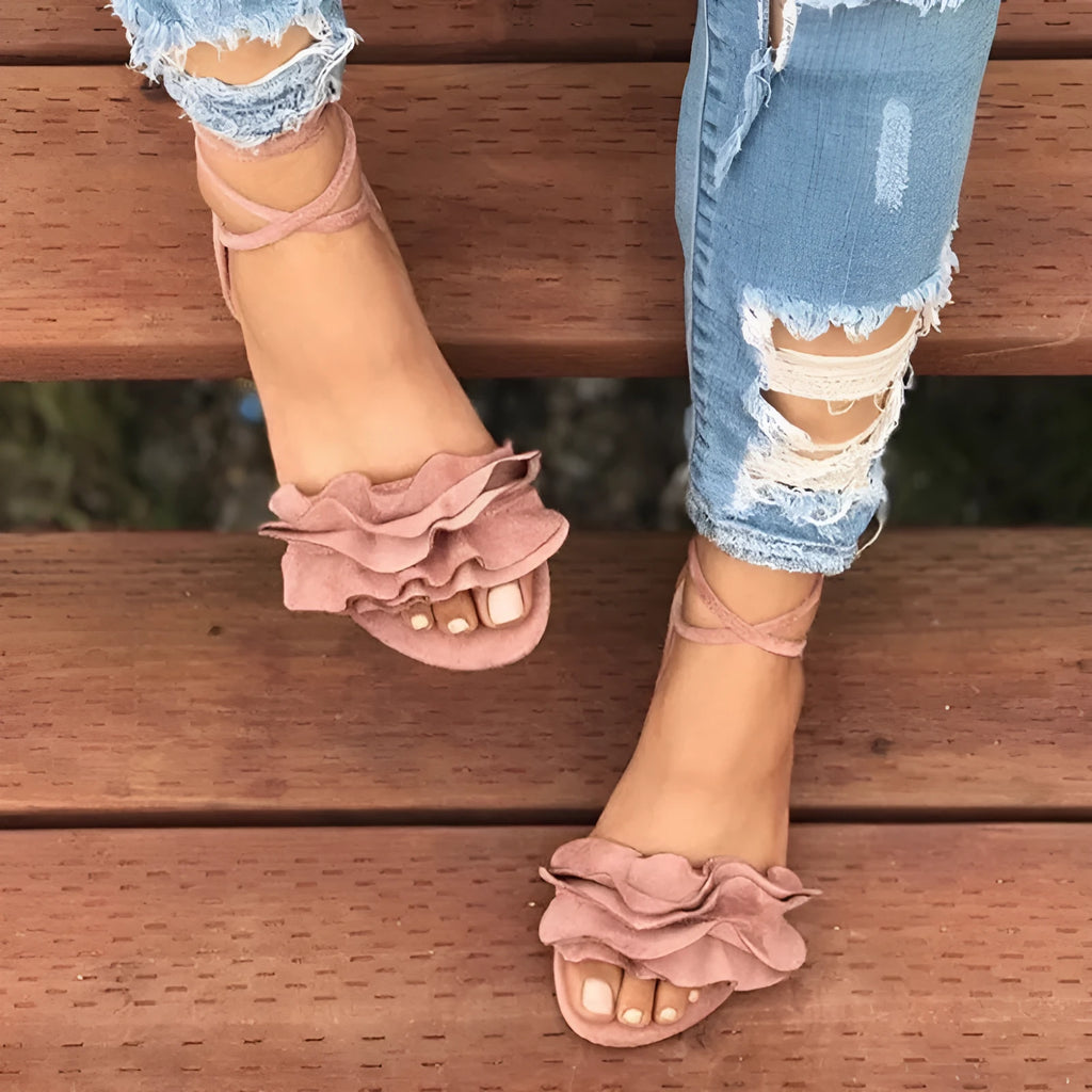 Women's plus size suede flower flat sandals with ankle strap in black, side view