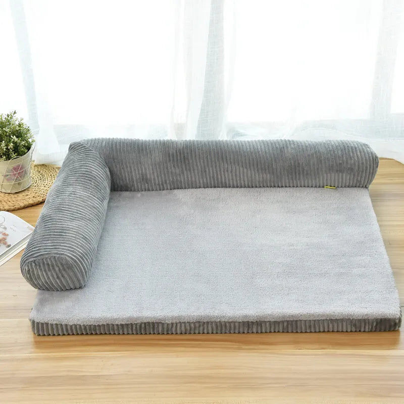 Corduroy dog sofa bed in grey, showing high sides and non-slip base, placed on a wooden floor.