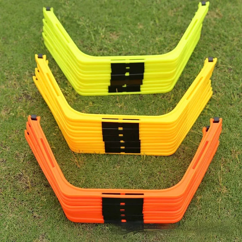 Six foldable yellow, green, and orange hexagon football agility training rings laid out on grass.