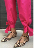 Women's leopard print pointed toe pumps with a chunky low heel and cross shoulder straps.