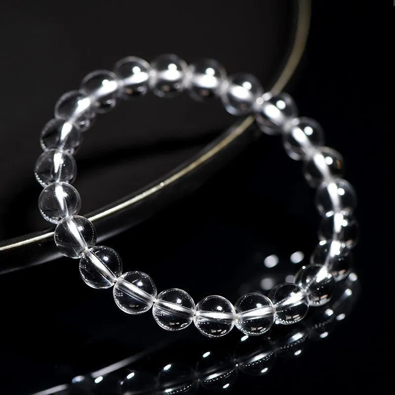 Natural white crystal bead bracelet with geometric design and round beads in various sizes.