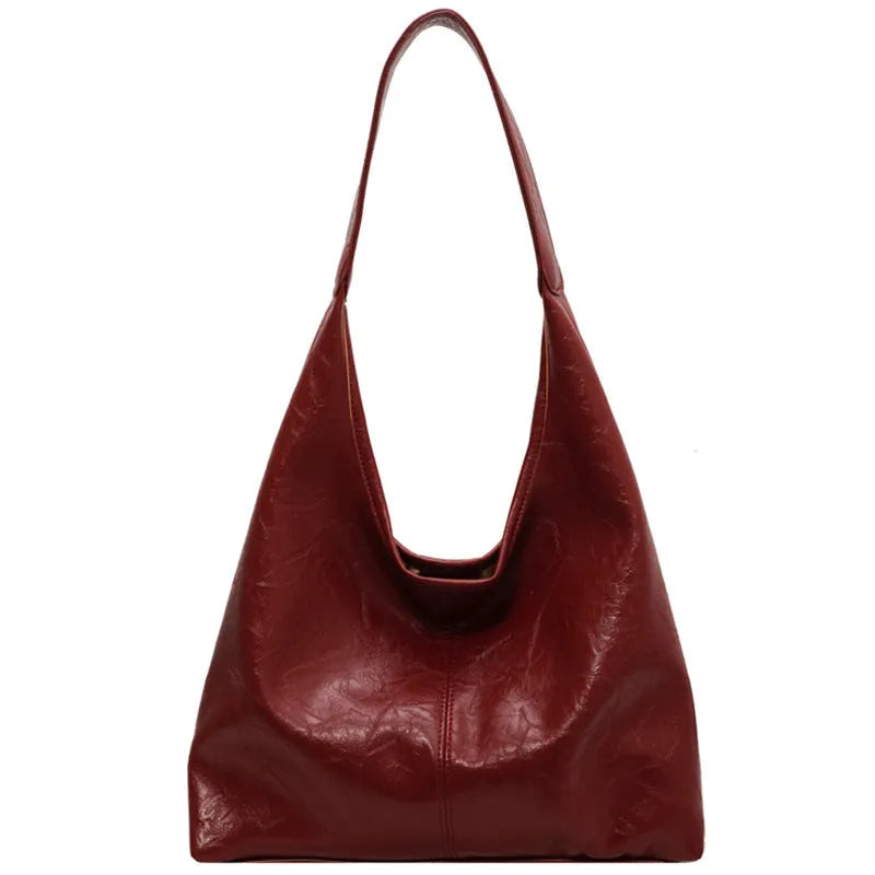 Casual soft PU leather large capacity shoulder bag in street trend style.