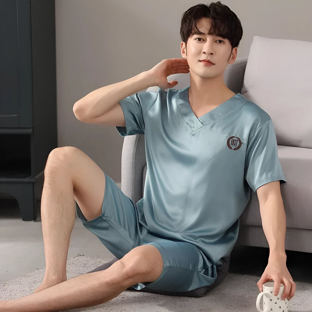 Man wearing a loose grey ice silk short-sleeve pajama shirt and matching shorts.