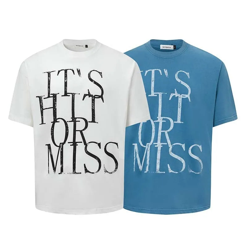 Man wearing a blue loose-fit T-shirt with a large white American retro style letter print on the front.