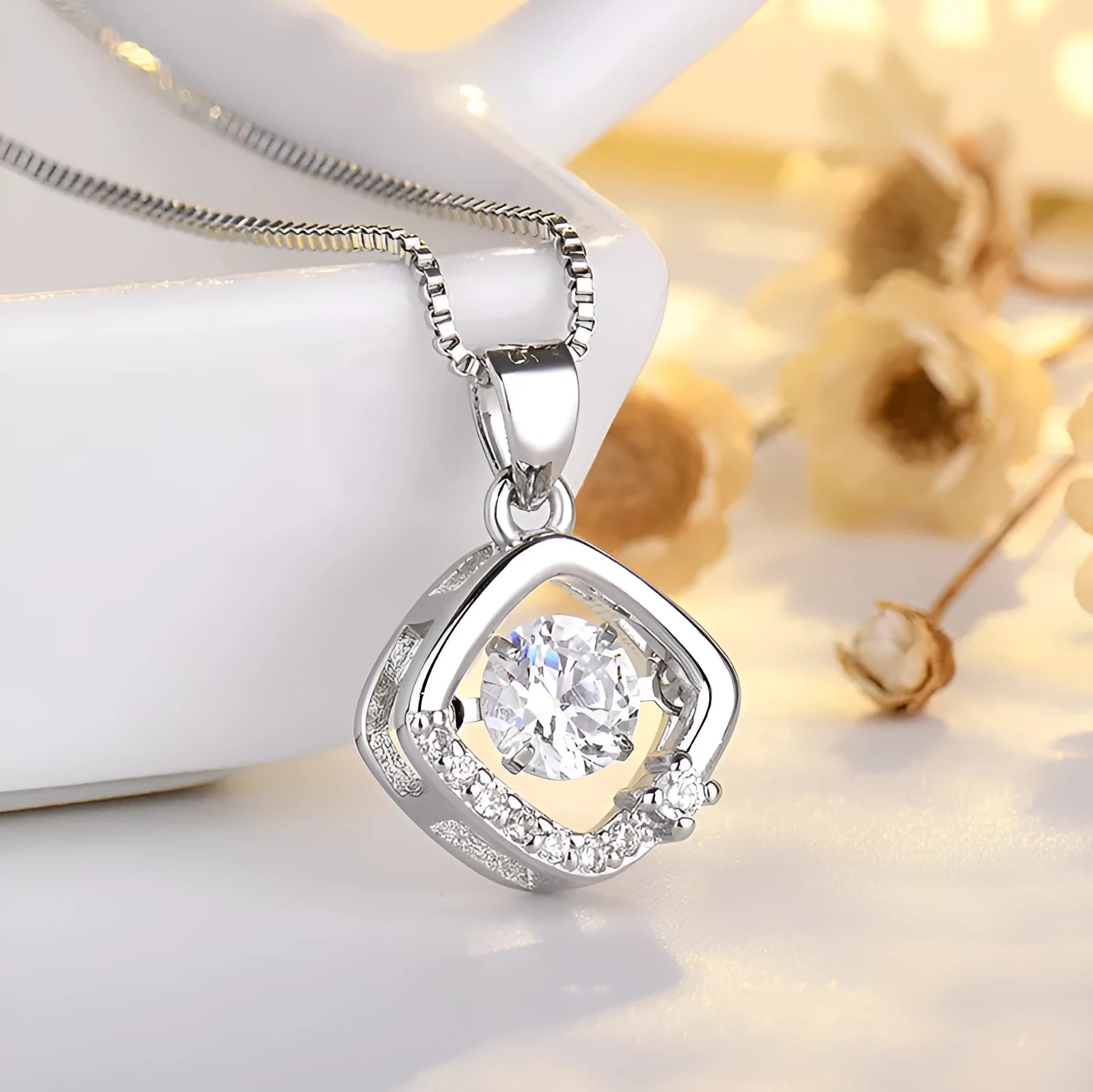 Silver heart-shaped pendant necklace with a crown and bow design on a sterling silver chain.