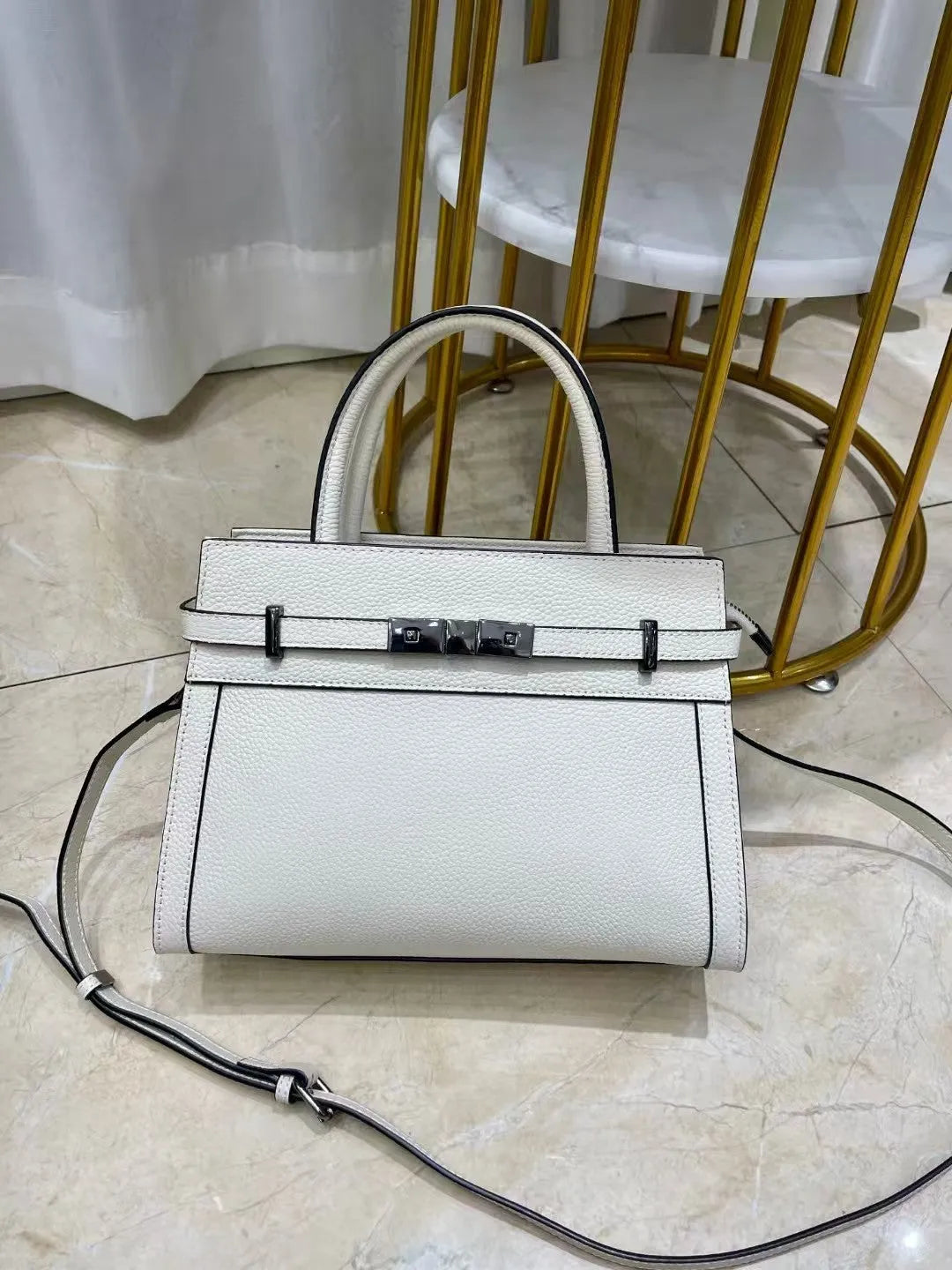 Small square genuine leather shoulder bag in horizontal design with multiple internal pockets