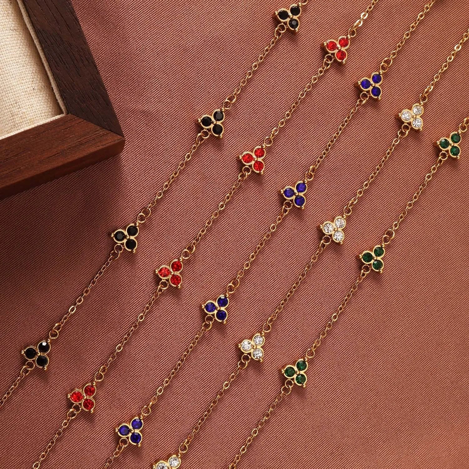 Stainless steel women's bracelet with three triangular diamond motifs set with colourful zircon stones.