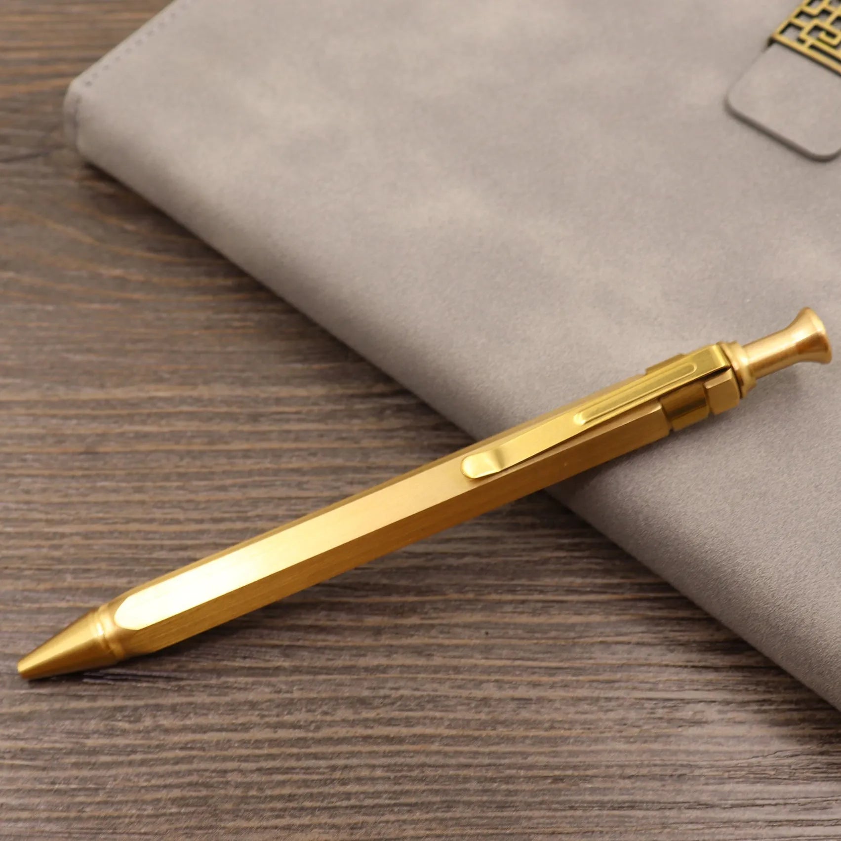 Retro brass tactical pen with press bolt-action mechanism and cylindrical metal barrel