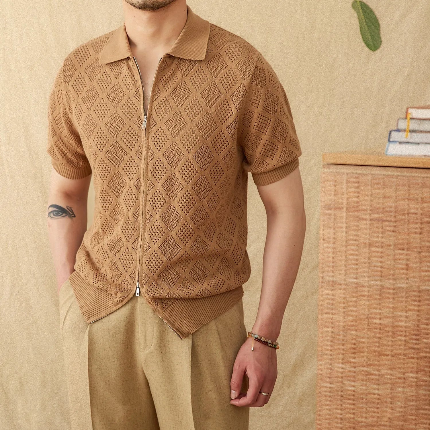 Light coffee coloured zip-front cardigan with short sleeves and a lapel collar laid flat.