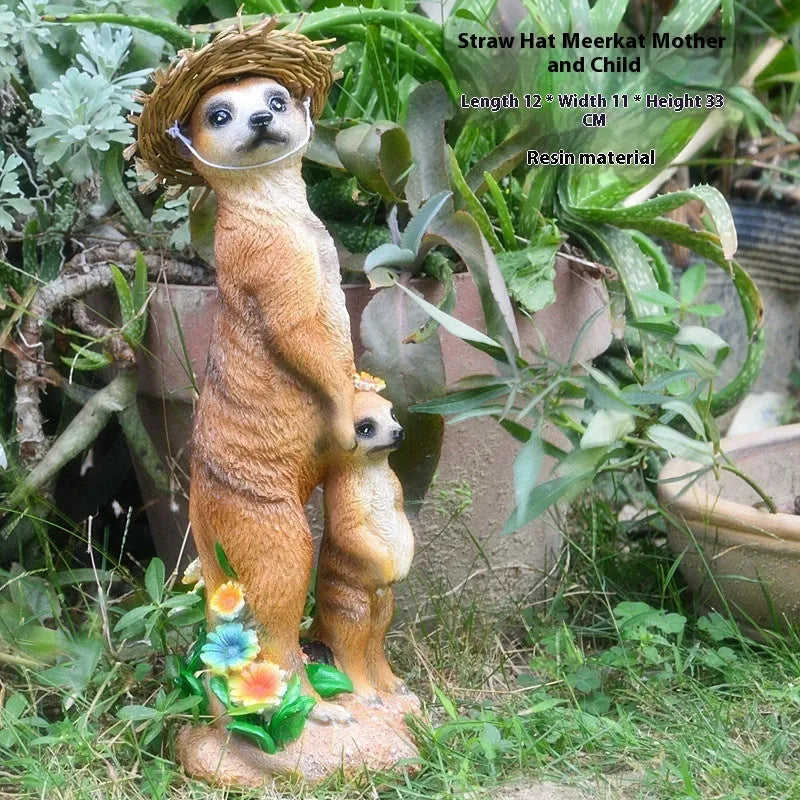 Three small straw hat mongoose garden ornaments: one with a baby, one holding a rake, one holding a shovel.