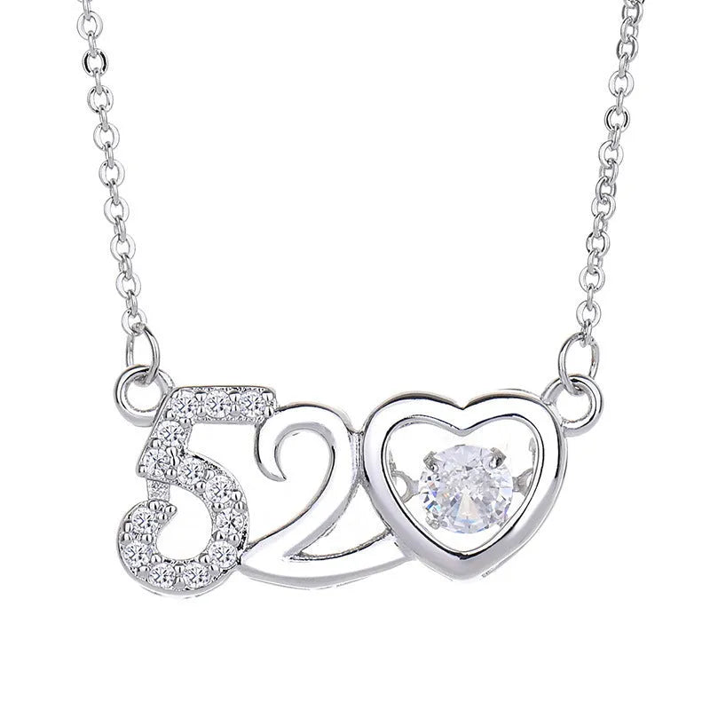Silver heart-shaped pendant necklace with a crown and bow design on a sterling silver chain.