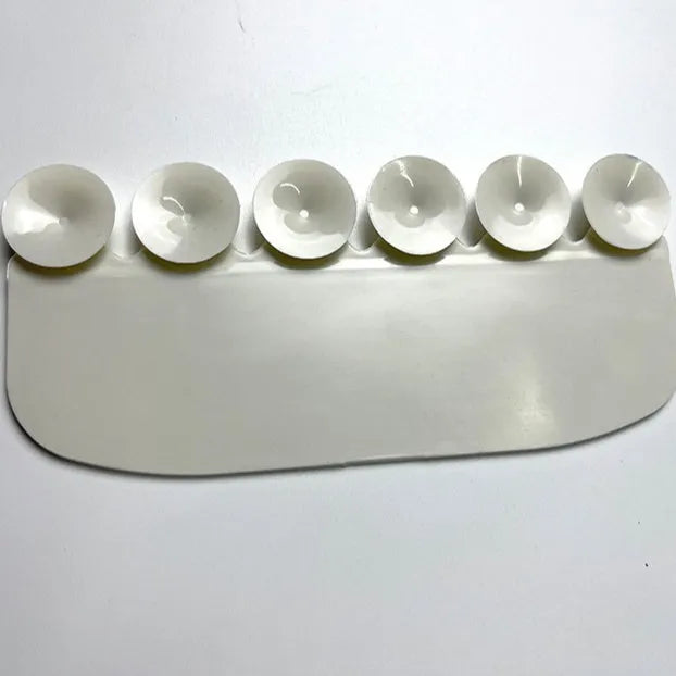 White plastic toilet urine guard for children's toilet training placed on standard toilet seat