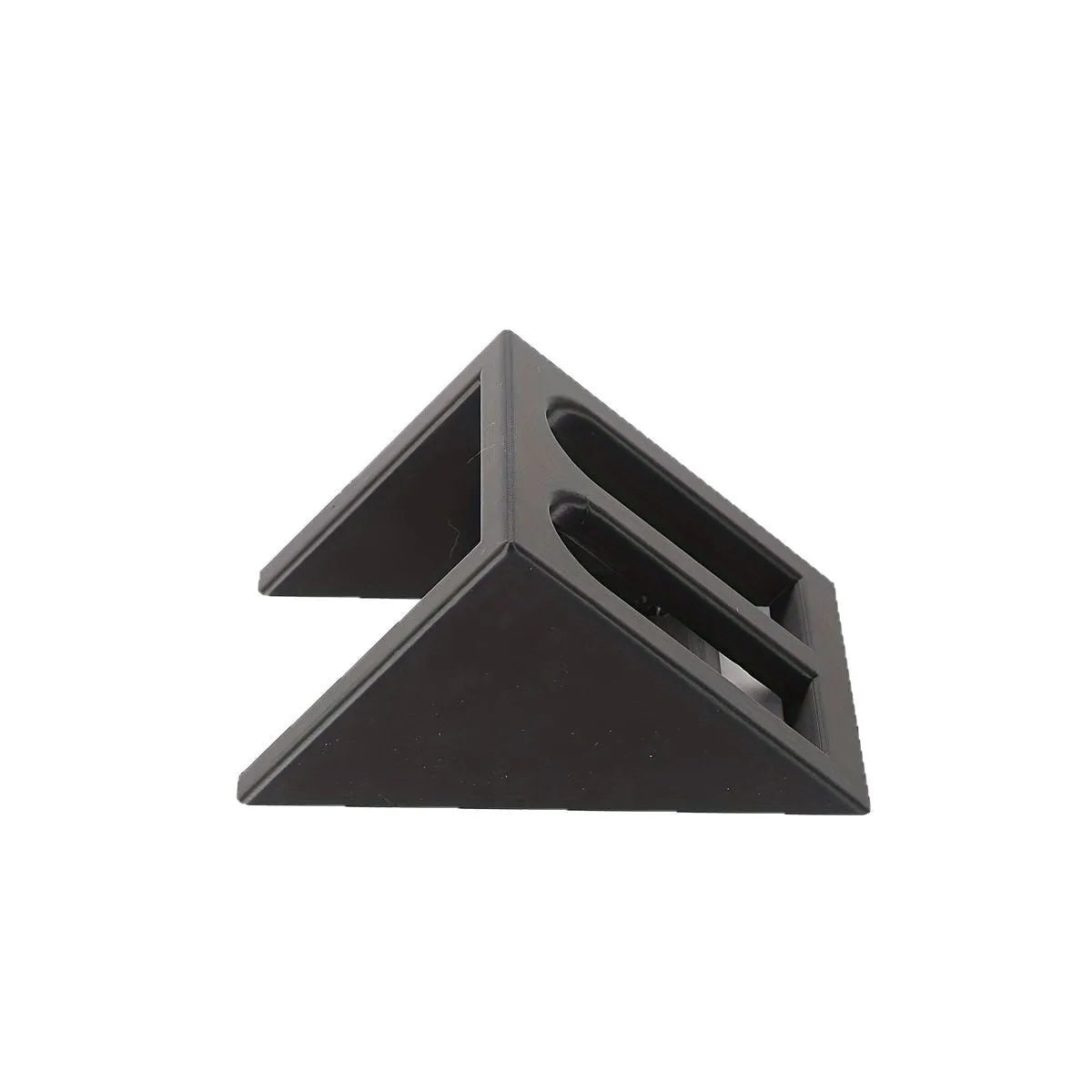 Black punk-style plastic pistol display stand on a surface, showing its compact size and cradle design.