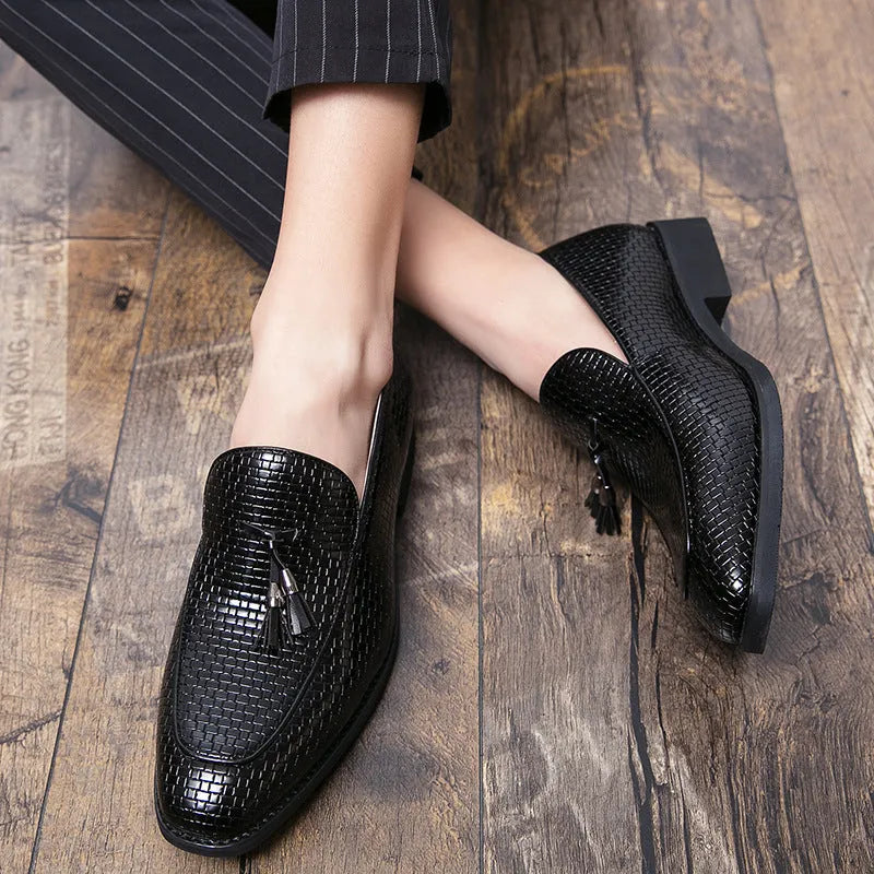 Men's black pointed slip-on business shoes with tassel detail on artificial PU leather upper